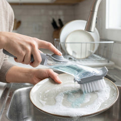 Refillable soap dispensing dish scrub brush with liquid soap
