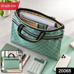 A green patterned document bag with an open top, holding various papers and notebooks, on a desk with a phone and calculator.