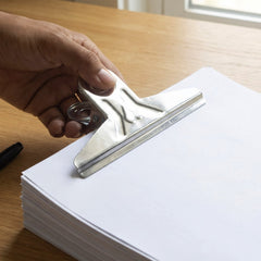 Binder clip holding a stack of documents