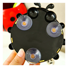 Back of ladybug toothbrush holder showing suction hook