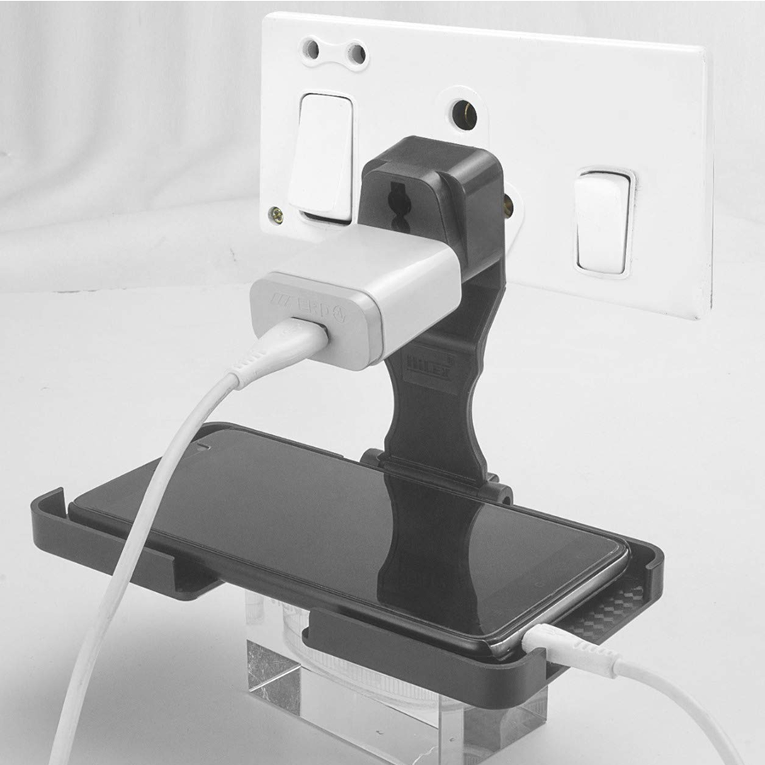 Black multi-purpose stand holding phone on wall socket