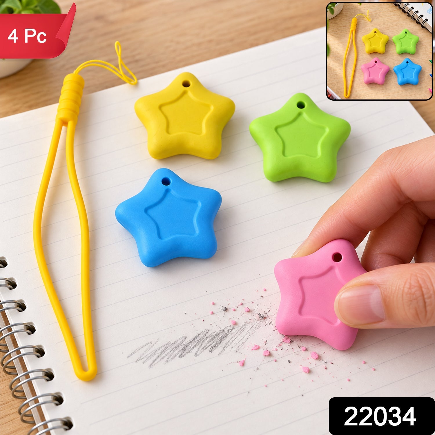 A hand holds a pink star eraser, removing pencil marks from a notebook page, with yellow, green, and blue star â€“ view 2