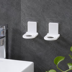 Self adhesive bottle holders mounted near sink