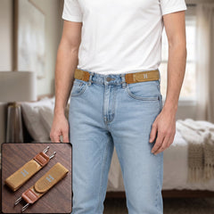 A man wearing light wash jeans and a white t-shirt, with two tan elastic belt hooks attached to his jeans.