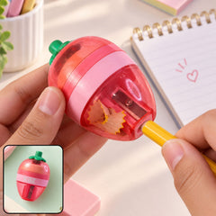 A person's hands sharpen a yellow pencil in a pink and red strawberry-shaped sharpener, creating wood shavings.