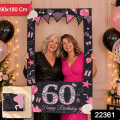 Two smiling women holding a black and pink 60th birthday photo booth frame; a small inset shows the folded banner and