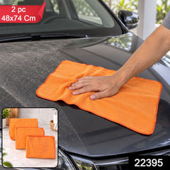 A hand cleans a dusty black car hood with an orange duster cloth, with two folded cloths and product details inset.