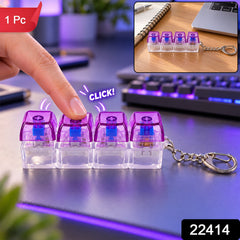 A hand presses a purple and clear four-key keyboard switch keychain, with a smaller inset image on a desk and a "1 Pc" label.