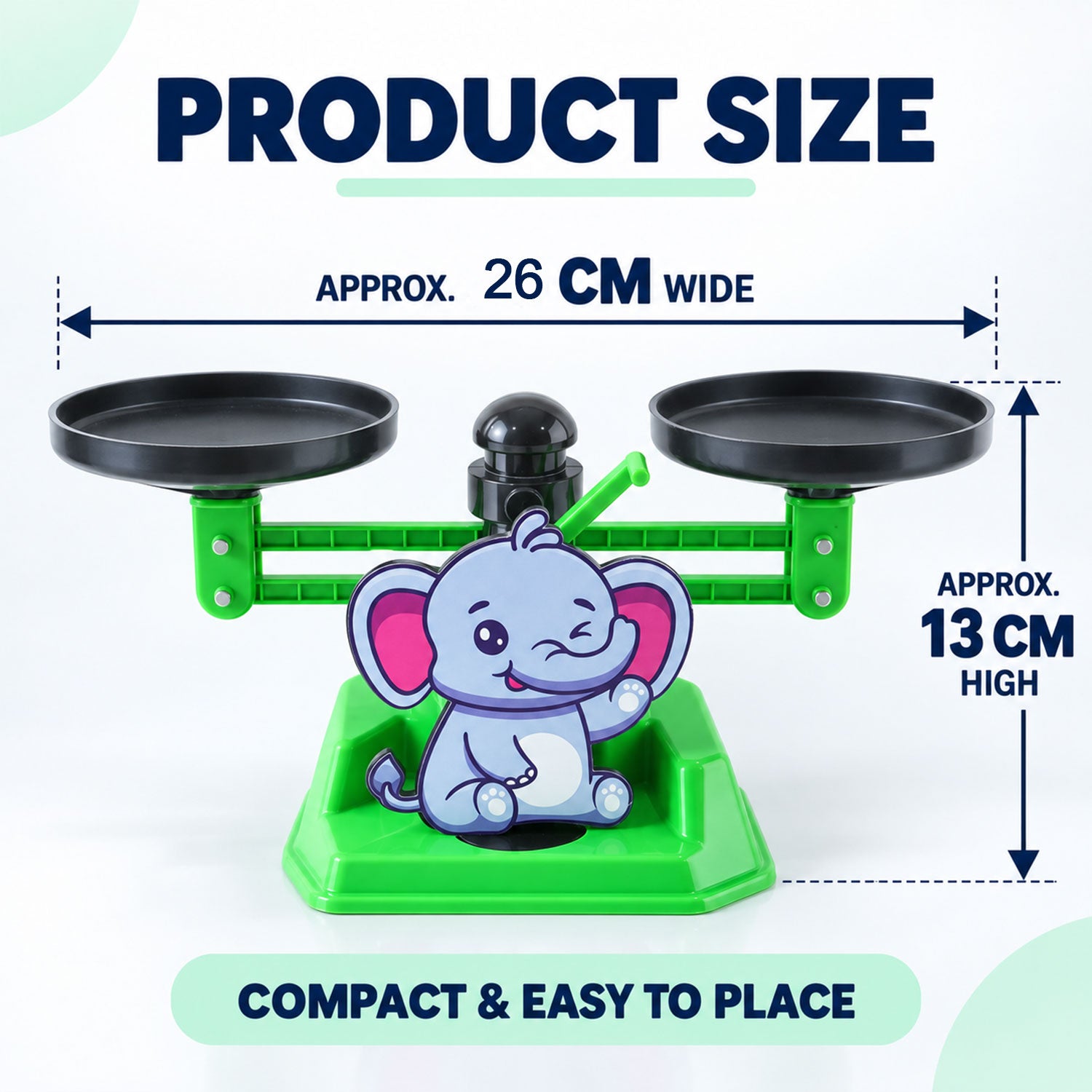 A green elephant math balance scale with black pans, showing approximate dimensions of 26 cm wide and 13 cm high.