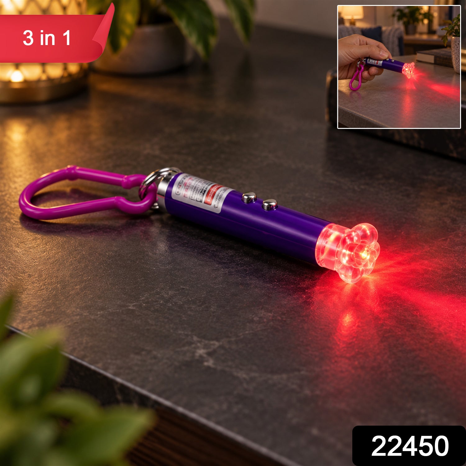 A purple laser pointer keychain with a clear flower cap illuminates a red light pattern on a dark surface, with an inset
