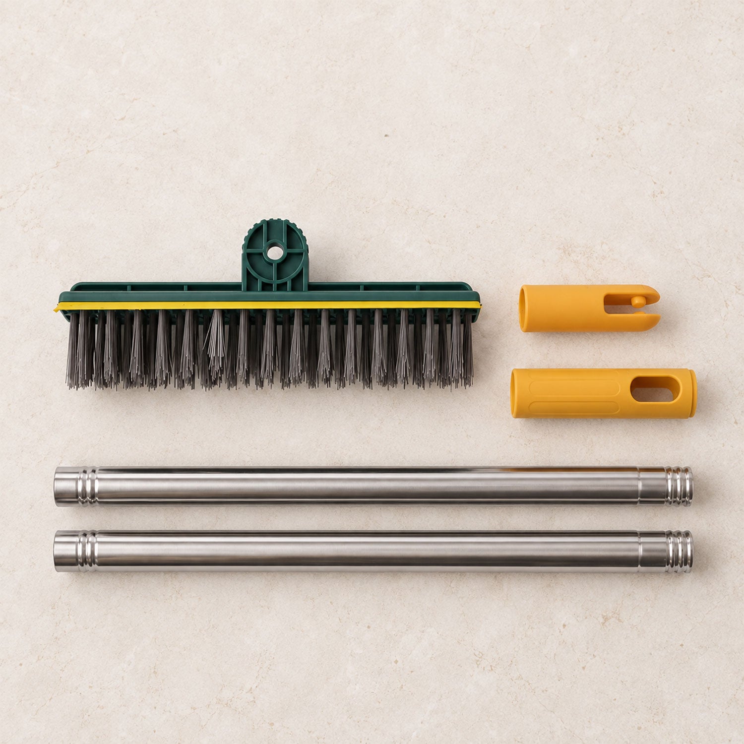 The disassembled green and yellow scrub brush components, including the brush head, two handle pieces, and two yellow