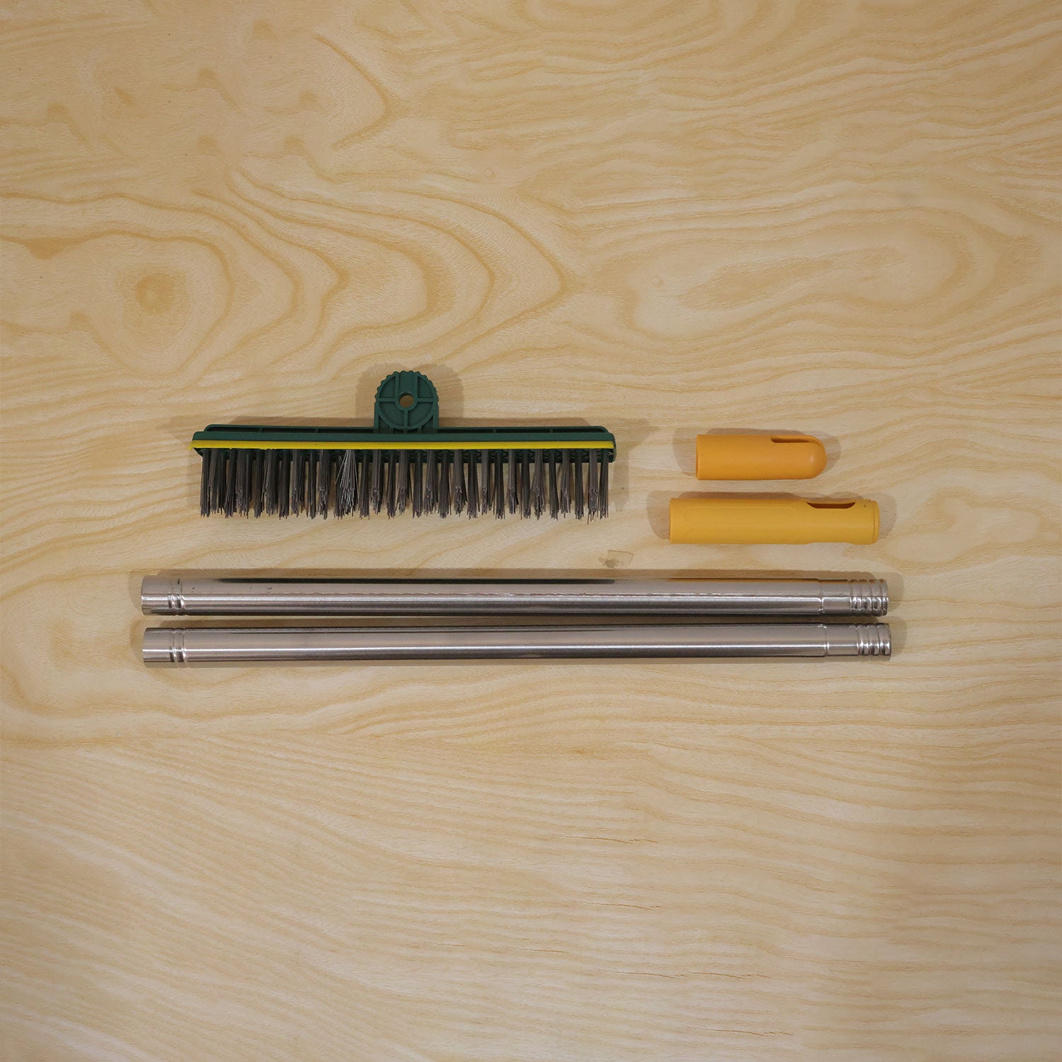 The disassembled green and yellow scrub brush components, including the brush head, two handle pieces, and two â€“ view 9