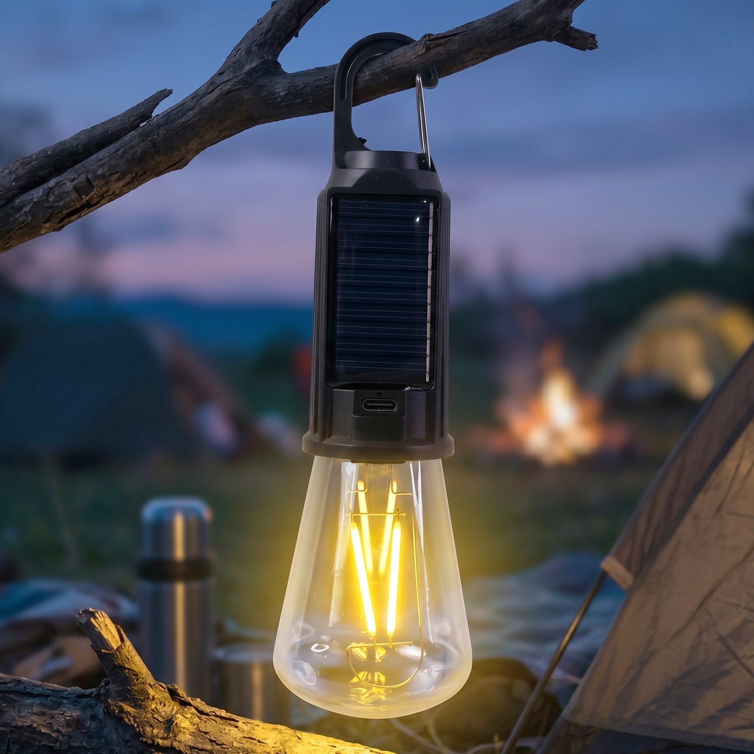 Camping lamp hanging inside a tent, providing warm light