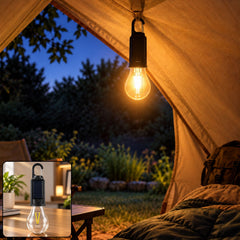 A lit LED bulb hangs within a tent, casting a warm glow on the interior and the outdoor evening landscape.