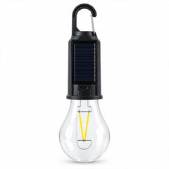 A clear, unlit LED bulb with a black solar panel top and carabiner clip stands upright on a white background.