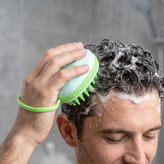 Scalp massager brush used while shampooing hair