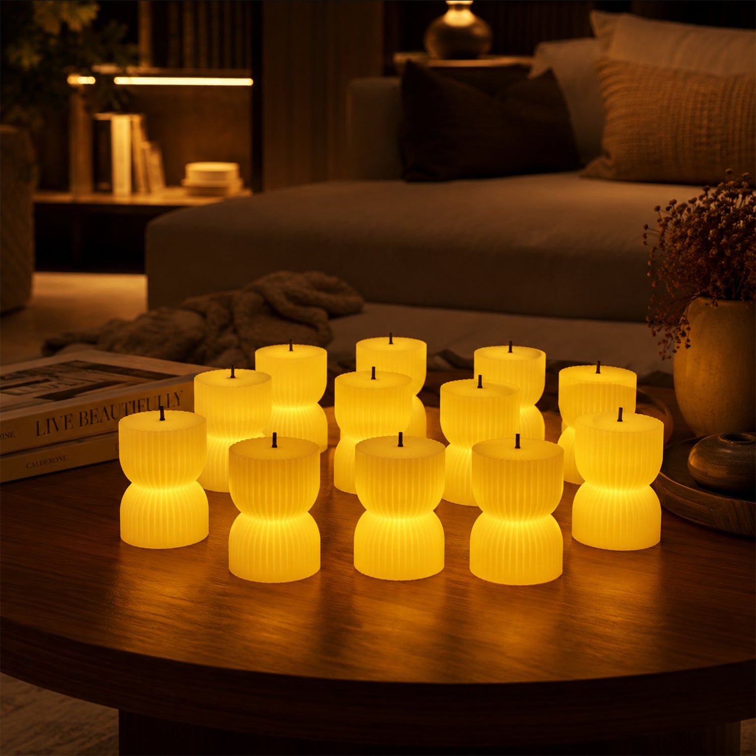 Twelve illuminated, ribbed, hourglass-shaped LED candles glow on a round wooden table in a dimly lit living room.