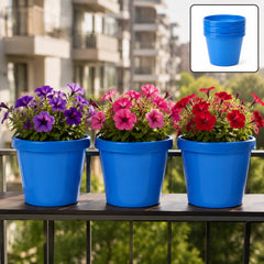 Three blue plastic planters with purple, pink, and red petunias on a balcony railing, with a stacked inset.