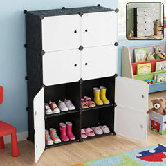 Black and white modular storage cabinet with four open compartments displaying children's shoes.