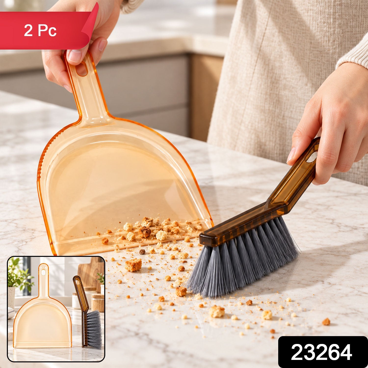 A person sweeps crumbs on a marble counter using a dark brown brush and amber dustpan, with a small inset showing the set.