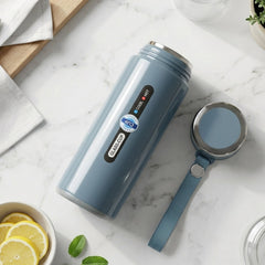 Vacuum insulated water bottle with cap and carrying strap