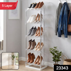 A five-layer shoe rack with clear shelves, displaying different footwear, next to a coat rack and plant.