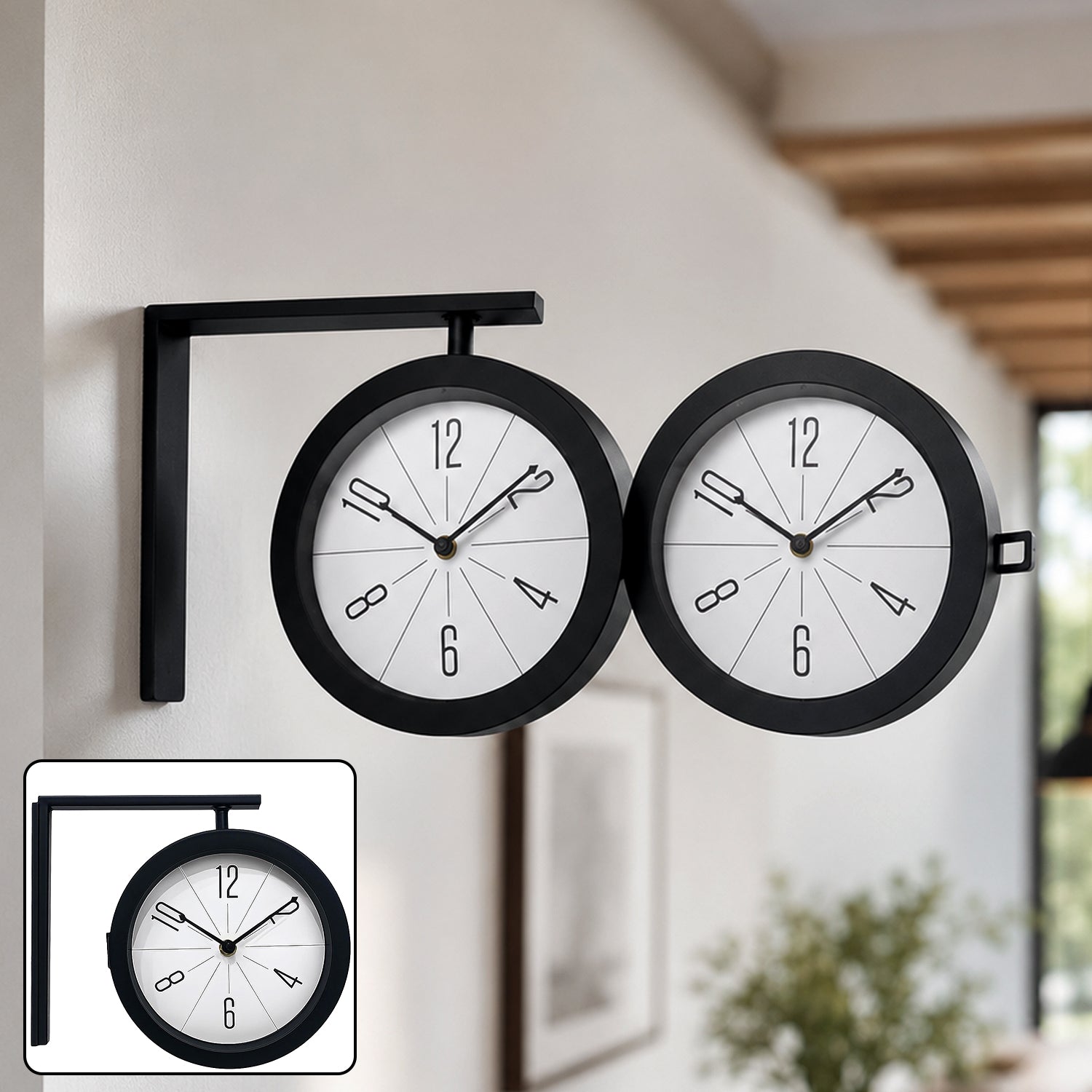 A black metal double-sided clock with a white face and minimalist numbers, mounted on a white wall.