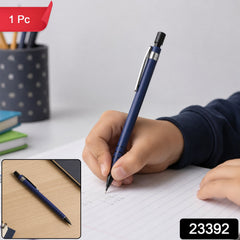 A child's hand writes with a blue mechanical pencil on lined paper, with a smaller inset image of the pencil on a â€“ view 2