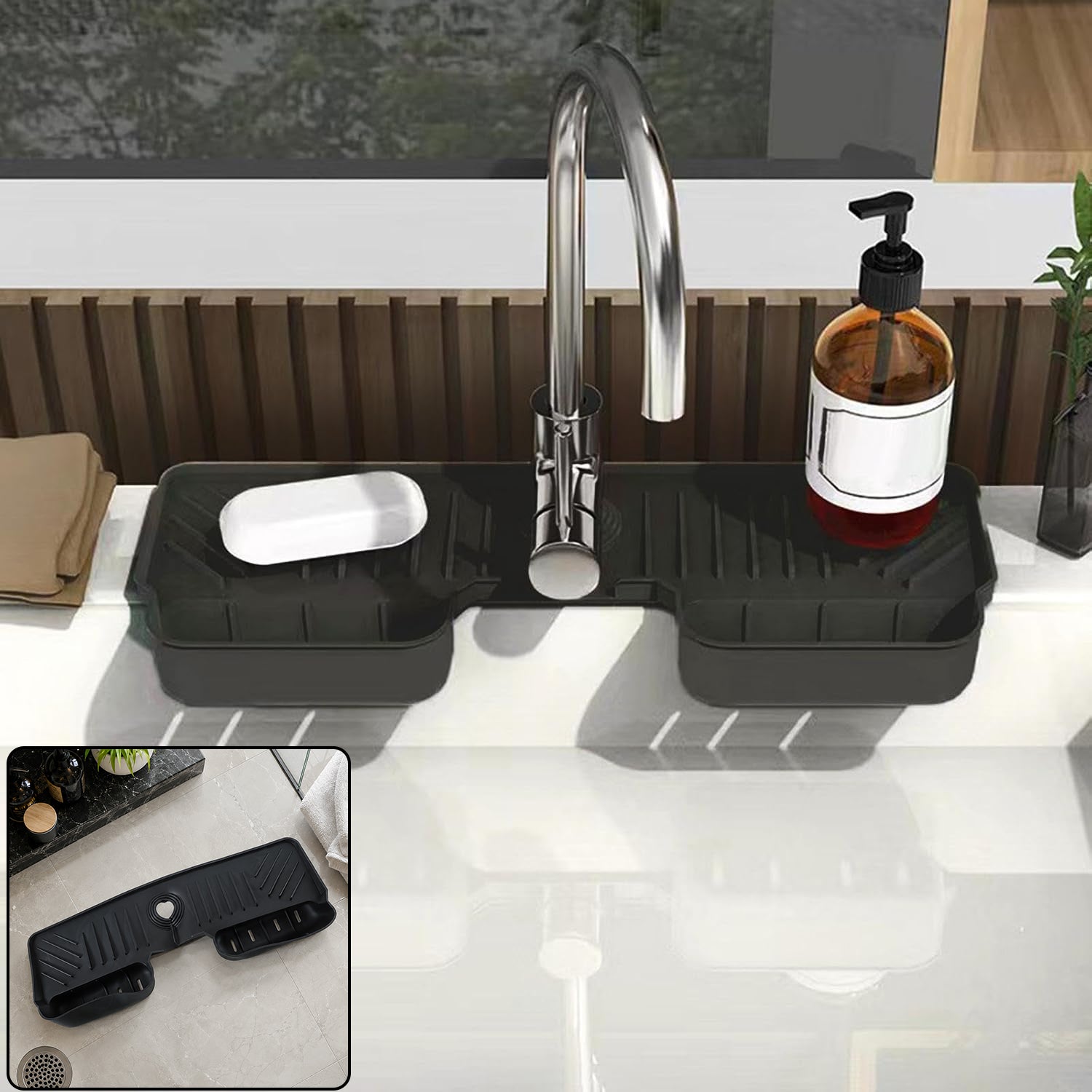 A black silicone faucet splash guard with a bar of soap and a pump bottle on a white kitchen sink.