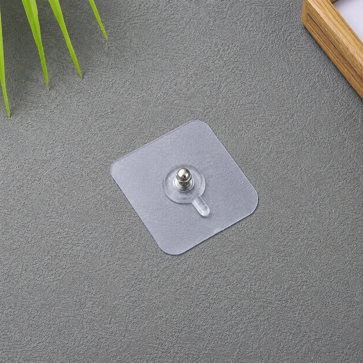 Transparent adhesive wall hook for frames