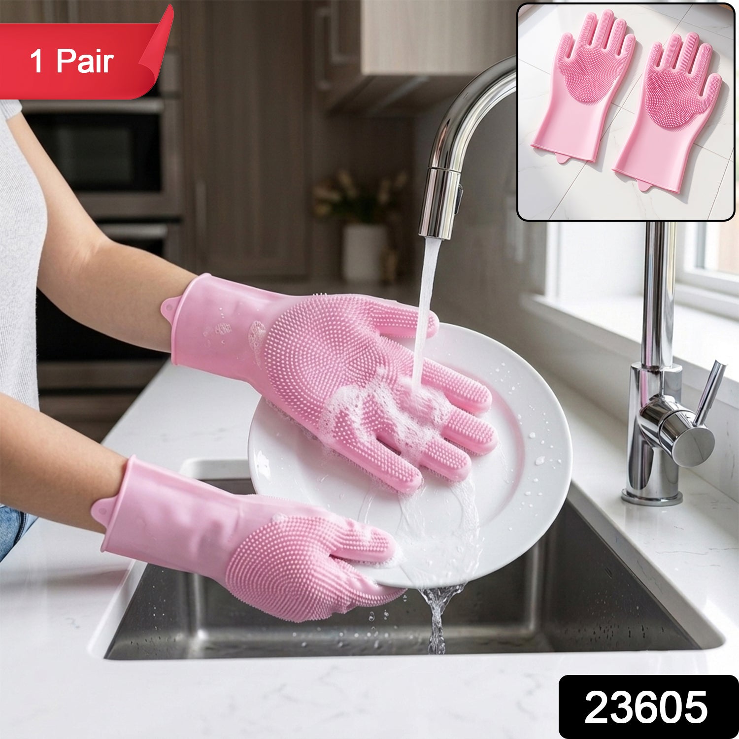 Hands wearing pink silicone gloves with scrubbing bristles washing a white plate under running water in a kitchen sink, with