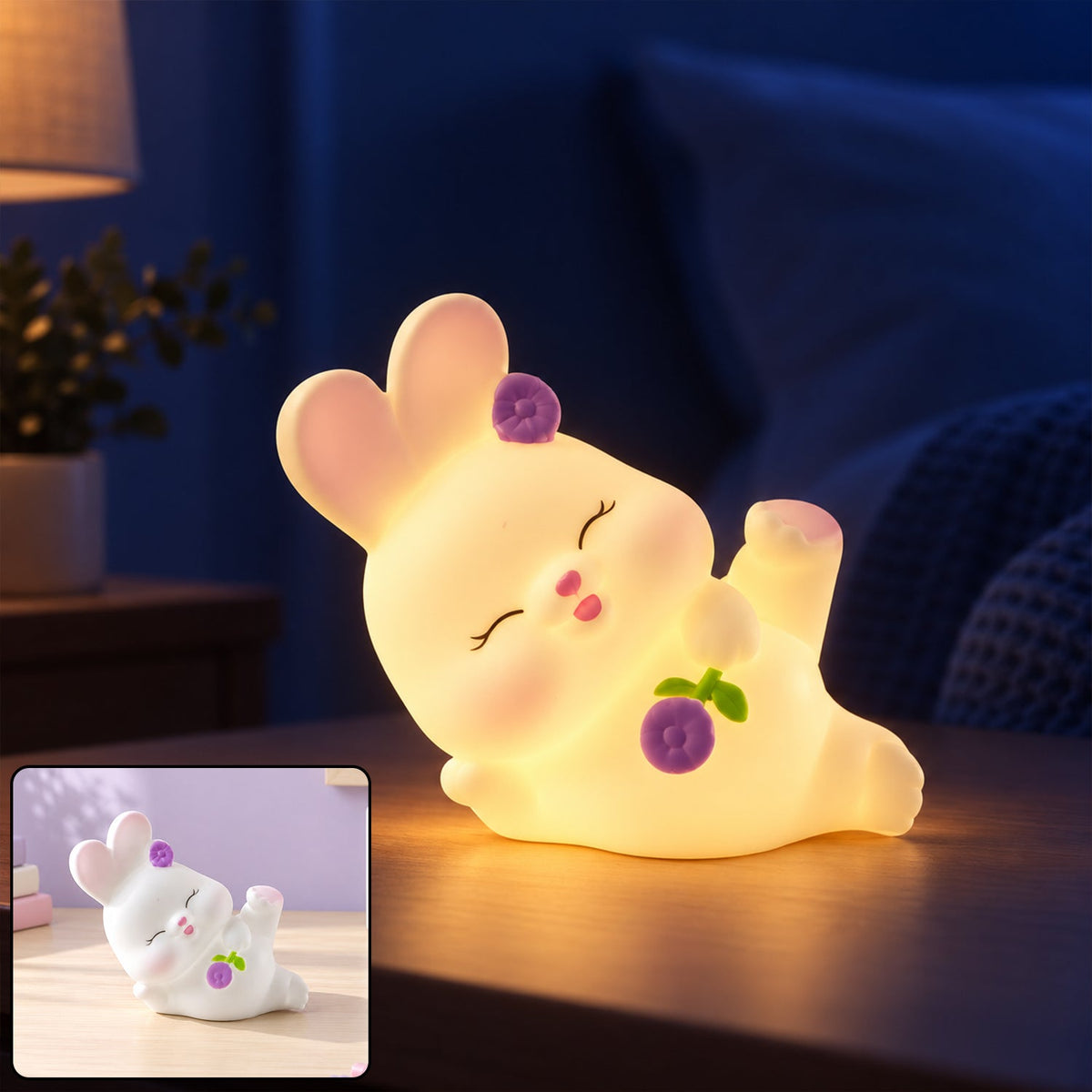 Cute reclining rabbit night light with warm glow on a wooden surface