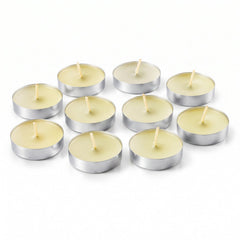 Ten unlit tea light candles with white wax and wicks, arranged on a plain white surface.