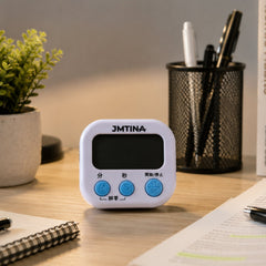 A white digital kitchen timer with blue buttons is angled on a white background, showing its simple design.