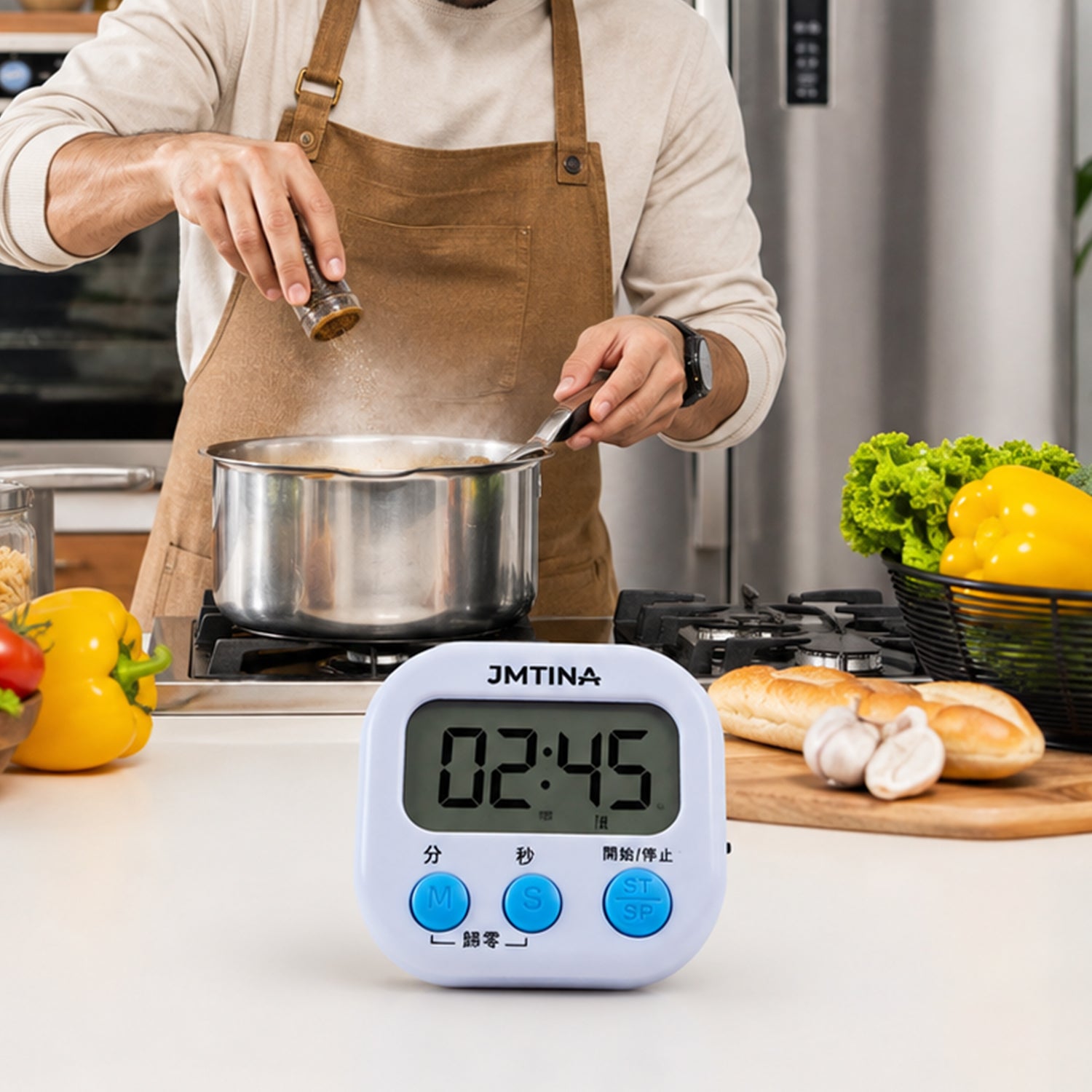 A white digital kitchen timer with blue buttons sits next to its white packaging box on a light wooden surface.