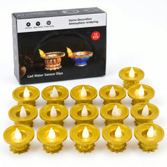 Fifteen gold plastic LED diyas with glowing flames arranged in rows in front of their product packaging box.