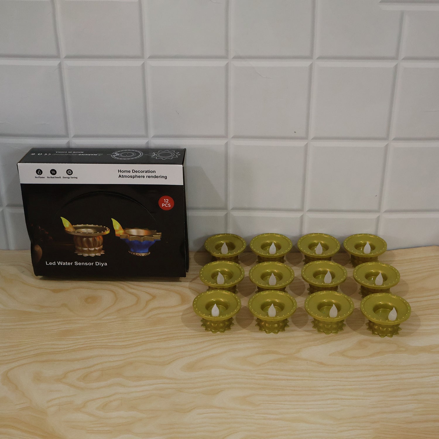 Gold plastic LED water sensor diyas used in a festive pooja setting