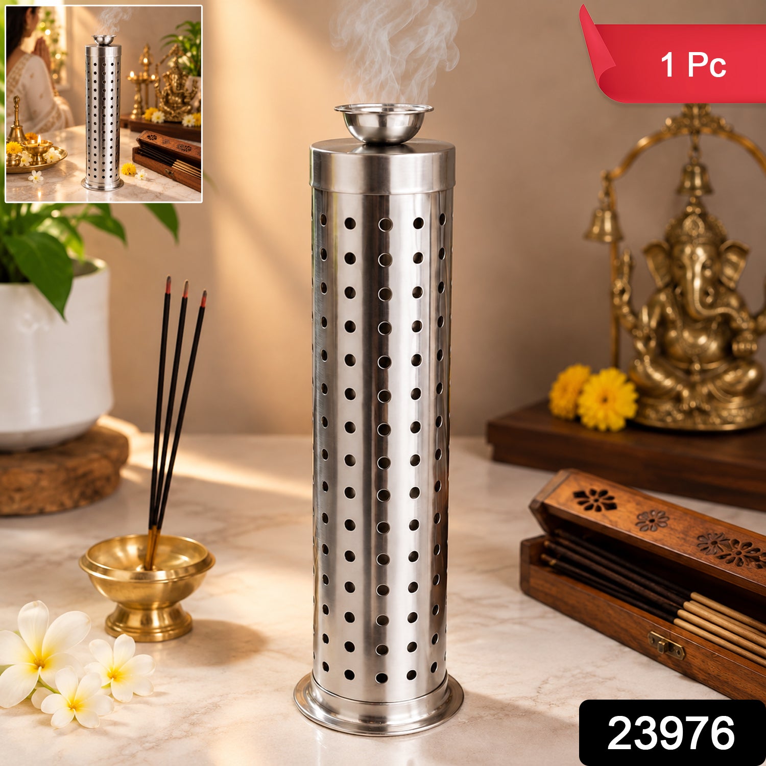 A shiny, perforated metal incense burner stands on a white marble surface, with a wooden box of incense sticks and a golden