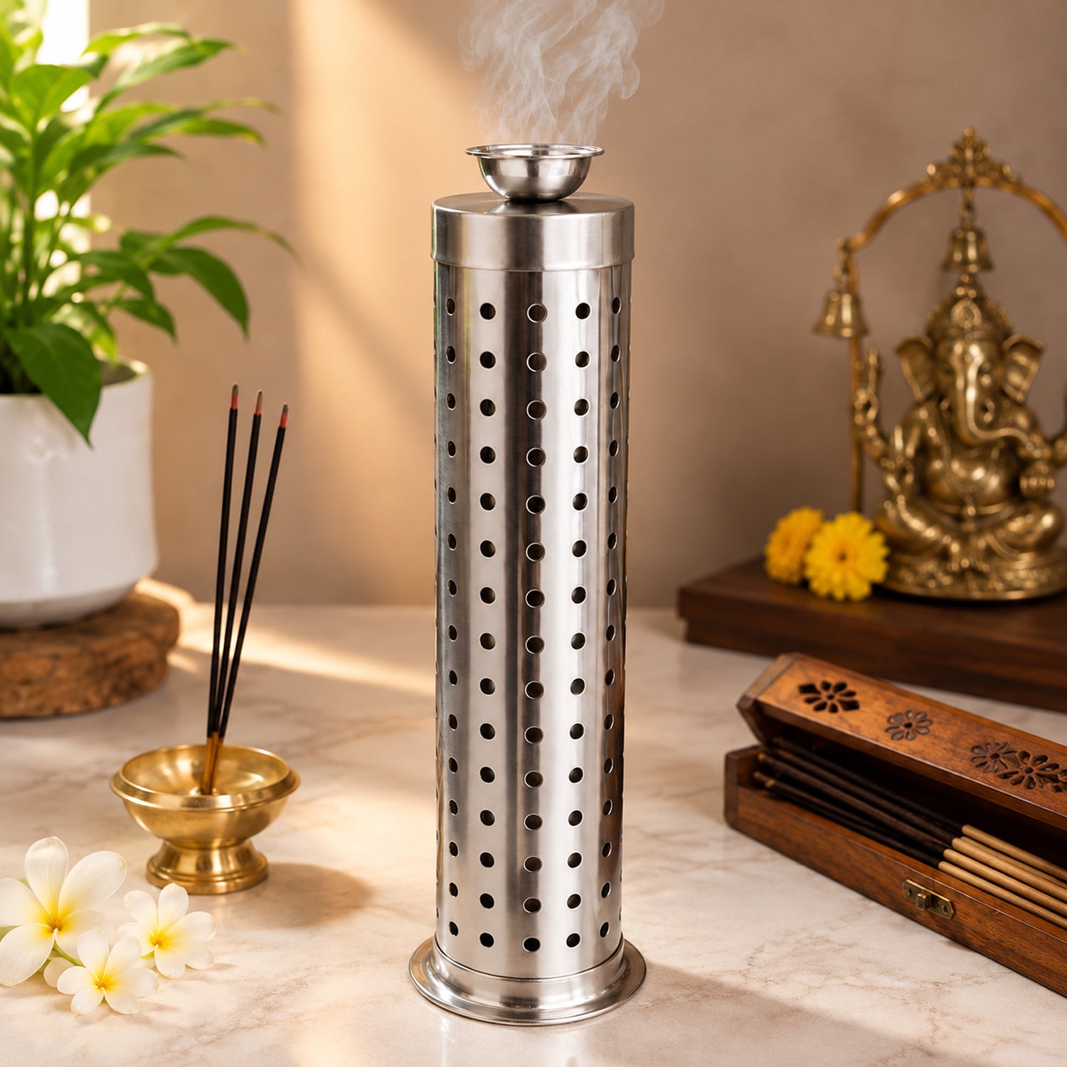 A tall, cylindrical, silver-colored metal incense holder with many small holes emits smoke from its top, surrounded by