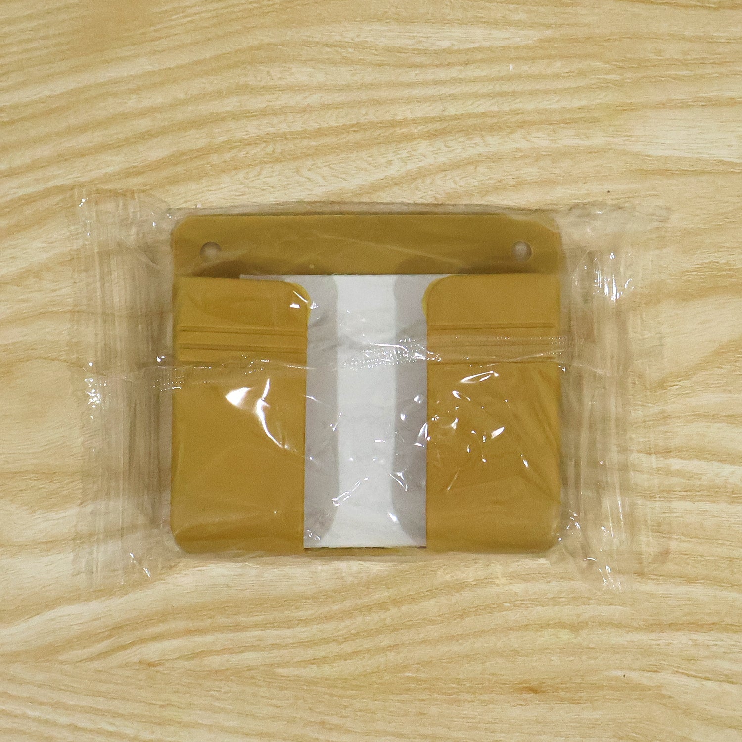 Adhesive wall mobile phone holder in a kitchen setting