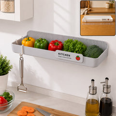 Wall mounted plastic kitchen drain rack holding vegetables