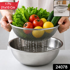 A person holds a stainless steel mesh strainer with fresh produce over a bowl of water, with product details.