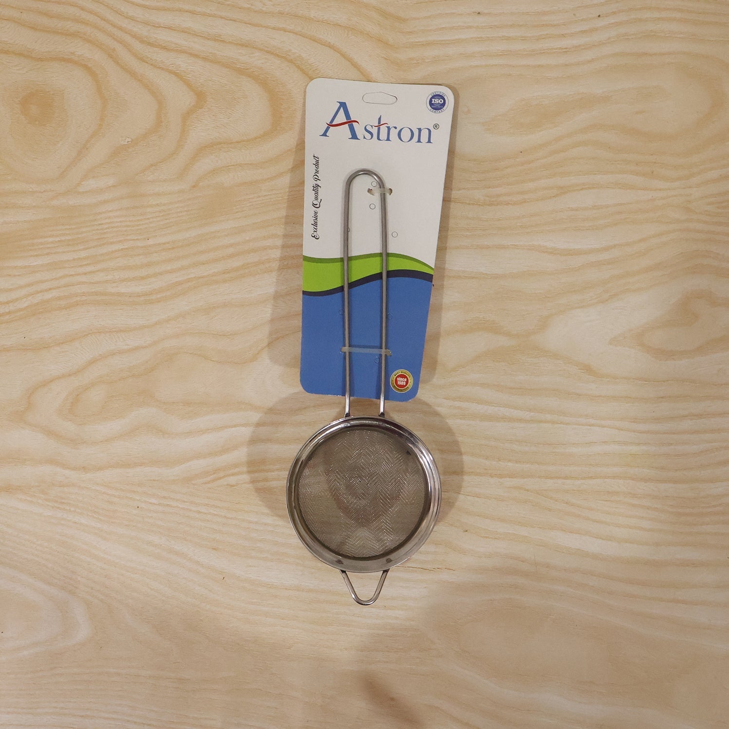 Tea strainer in daily kitchen use, held over a mug