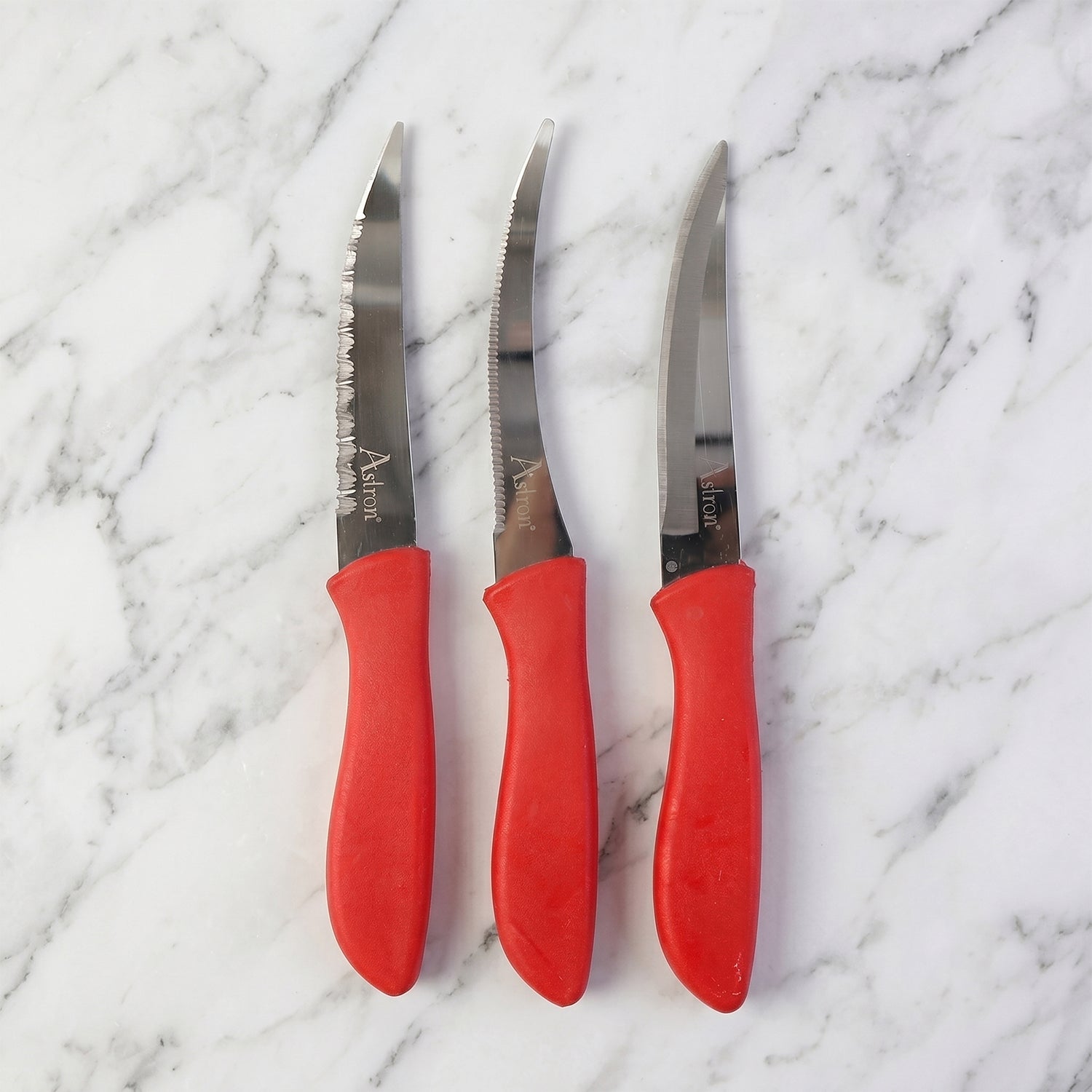 Sharp kitchen knife easily slicing a red tomato