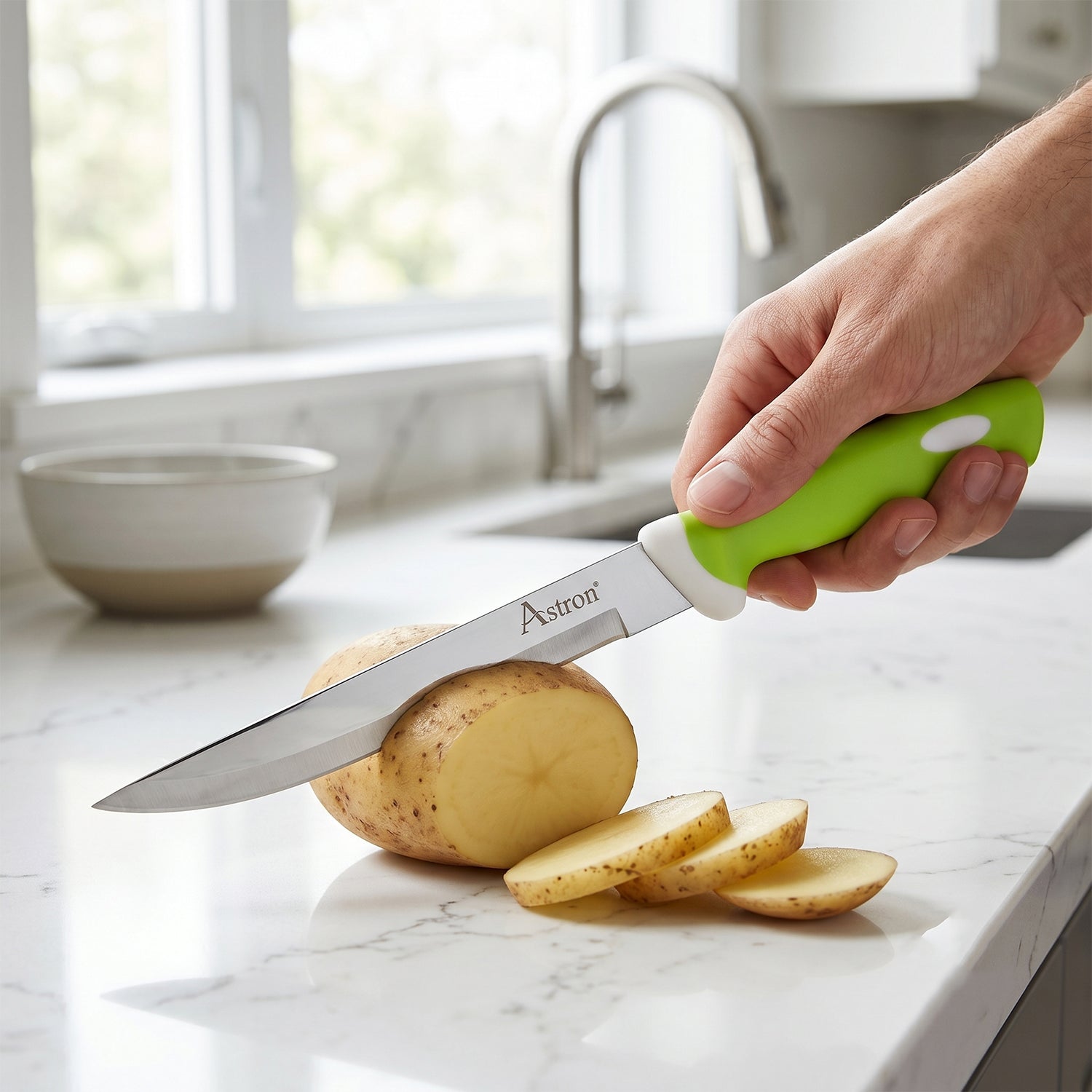 Hand holding 9-inch kitchen knife slicing vegetables