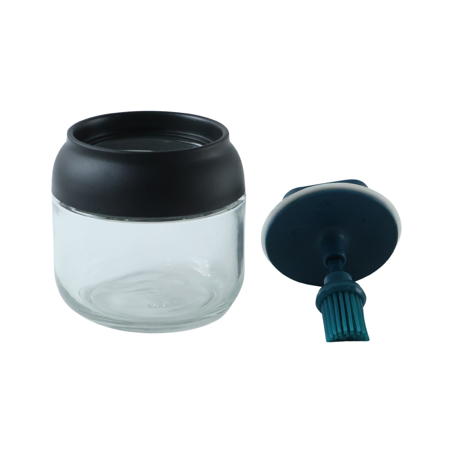 Round glass oil dispenser on white background