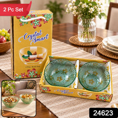 Two green glass bowls in a yellow box, with a vase of flowers and fruit on a wooden table. The image has a red banner and a