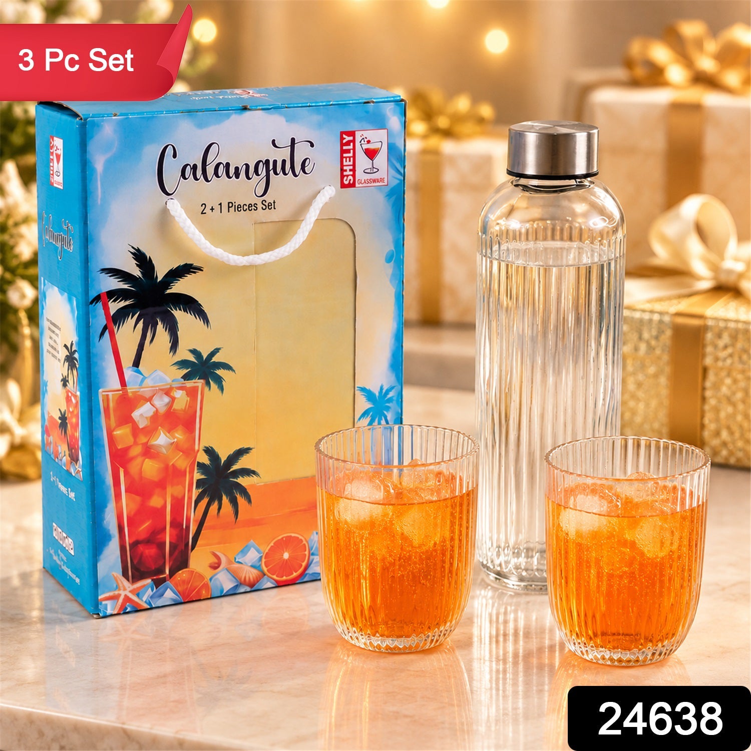 A blue gift box with a tropical design sits beside a clear ribbed glass bottle and two matching tumblers filled â€“ view 2