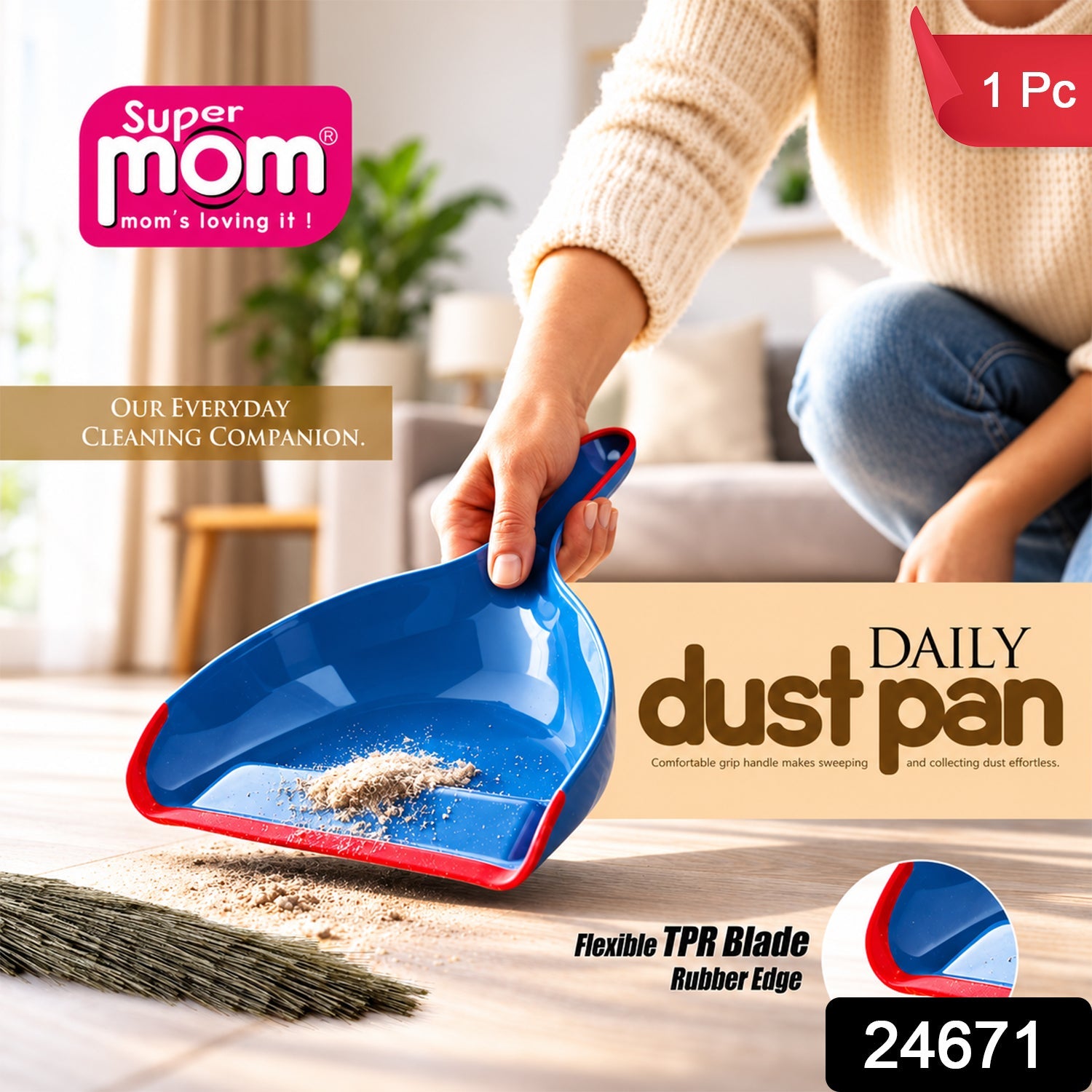 A person holds a blue and red dustpan with collected dirt, next to a broom on a wooden floor. â€“ view 2