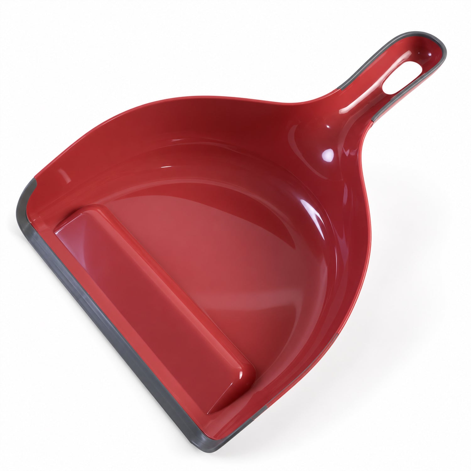 A red plastic dustpan with a grey rubber edge and handle sits on a white surface.
